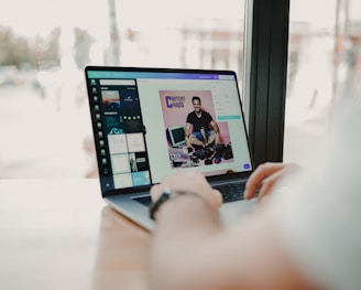 person using macbook pro on brown wooden table