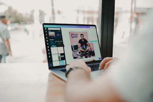 A professional photo of Amit Sharma working on marketing automation with a laptop and digital charts in the background.