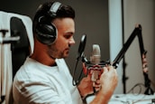 Artist wearing headphones, focused while recording vocals in the studio.