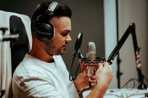 Close-up of a smiling person practicing Spanish pronunciation with headphones.