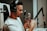 A person wearing headphones is speaking into a professional studio microphone, which is mounted on an adjustable arm. The individual appears focused and engaged with the recording process.