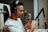 A person wearing headphones is speaking into a professional studio microphone, which is mounted on an adjustable arm. The individual appears focused and engaged with the recording process.