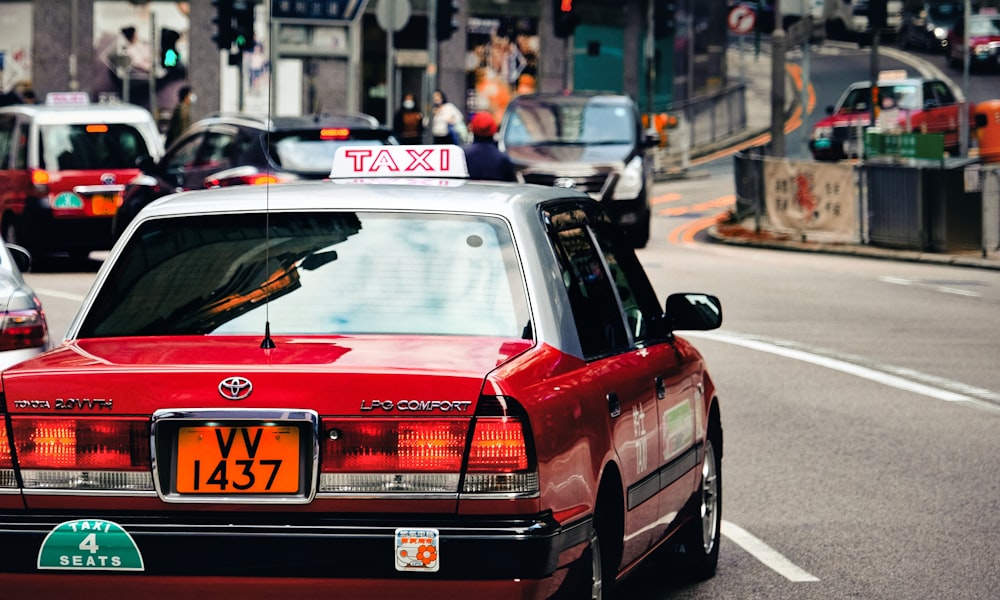 red mercedes benz c class on road during daytime