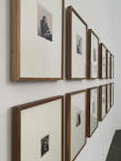 brown wooden framed pictures in 2 straight rows