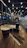 A cozy modern coffee shop interior with warm lighting and stylish tables.