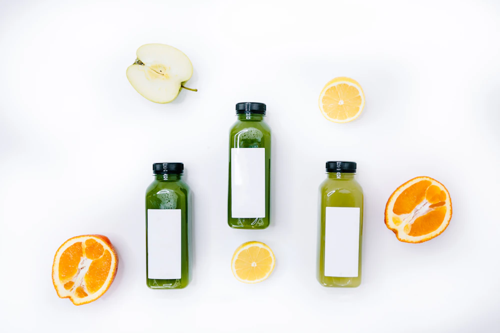 Trio of green smoothie bottles with fresh apple