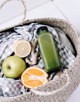 green disposable lighter beside orange fruit on brown woven basket