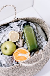 green disposable lighter beside orange fruit on brown woven basket