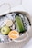 green disposable lighter beside orange fruit on brown woven basket
