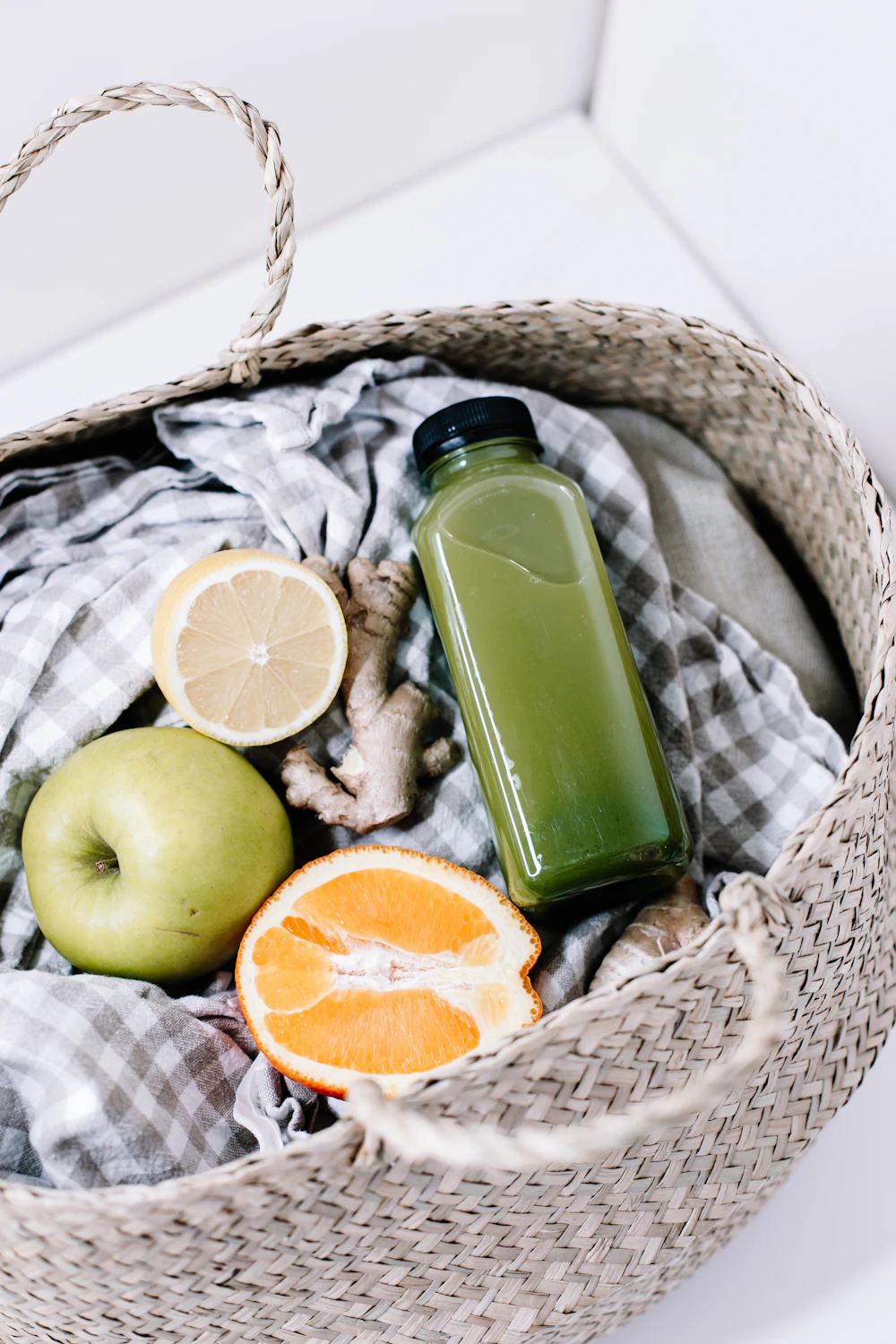 Green smoothie bottle with fresh ginger, lemon and apple