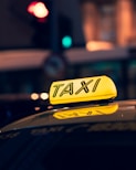 yellow taxi cab on road during night time