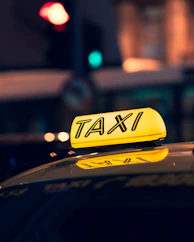 yellow taxi cab on road during night time