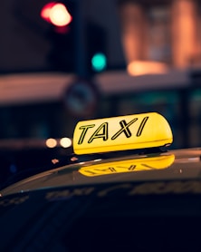 yellow taxi cab on road during night time