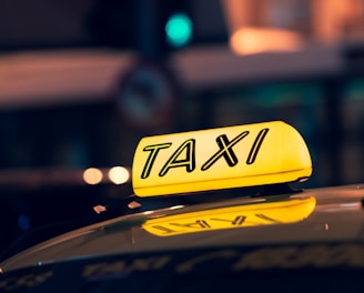 yellow taxi cab on road during night time