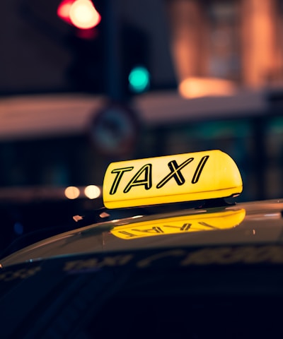 yellow taxi cab on road during night time