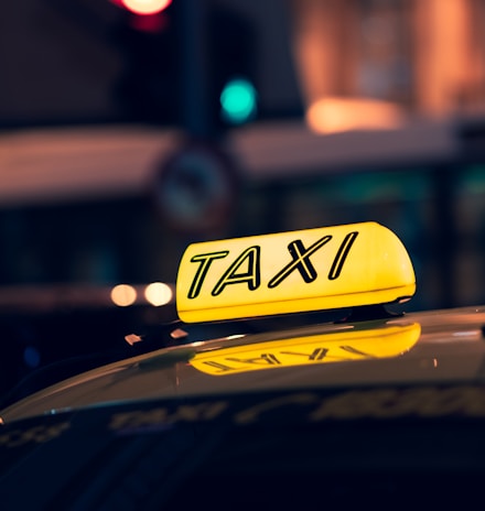 yellow taxi cab on road during night time