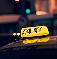 yellow taxi cab on road during night time