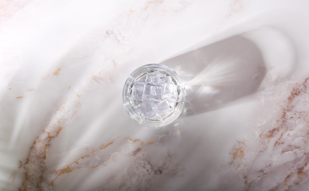 clear glass ball on white textile