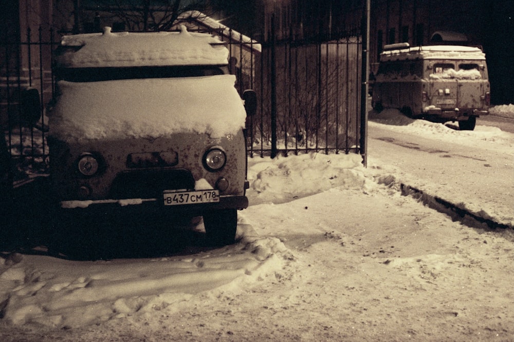 white and yellow van on snow covered ground during daytime