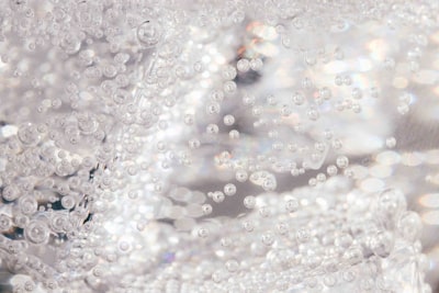water droplets on glass surface sparkling teams background