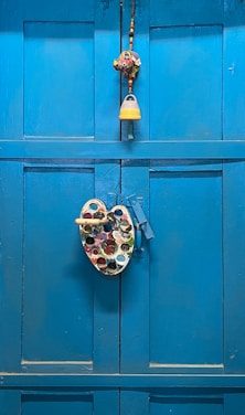 A painter carefully applying fresh paint to a wooden door in natural light