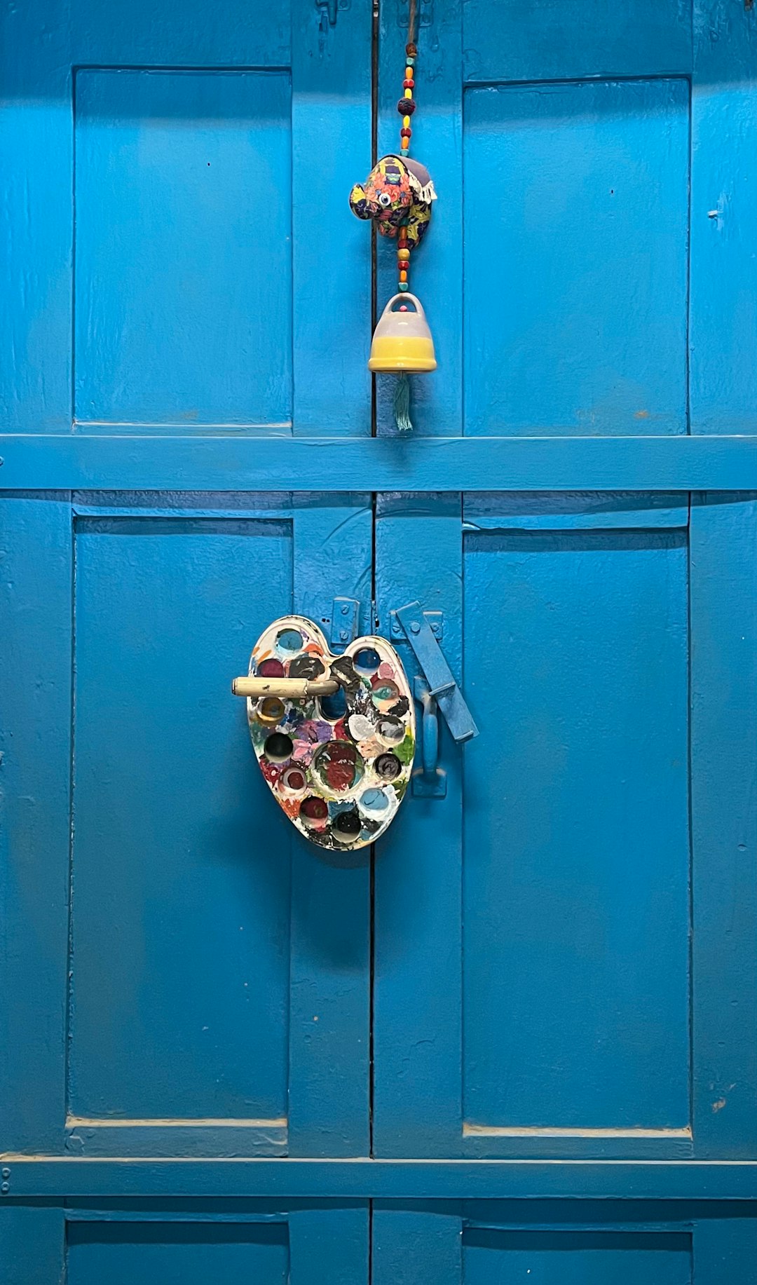 brass padlock on blue wooden door