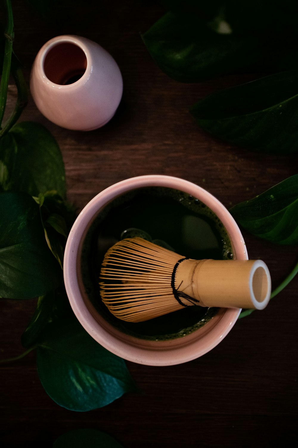 brown wooden brush on white ceramic mug