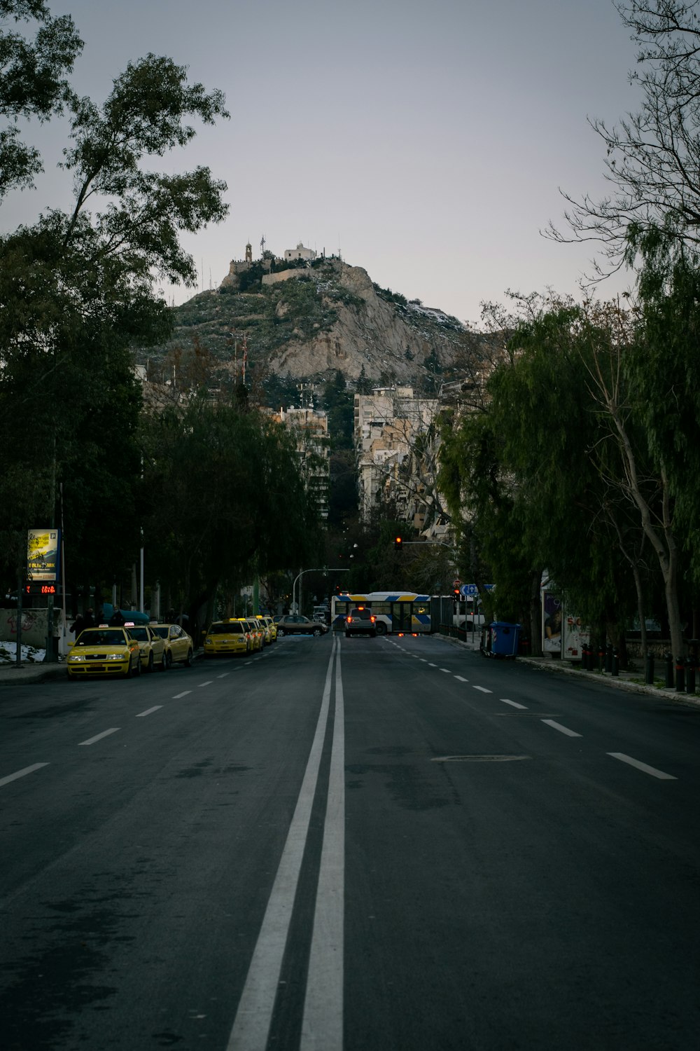 yellow car on road near mountain during daytime