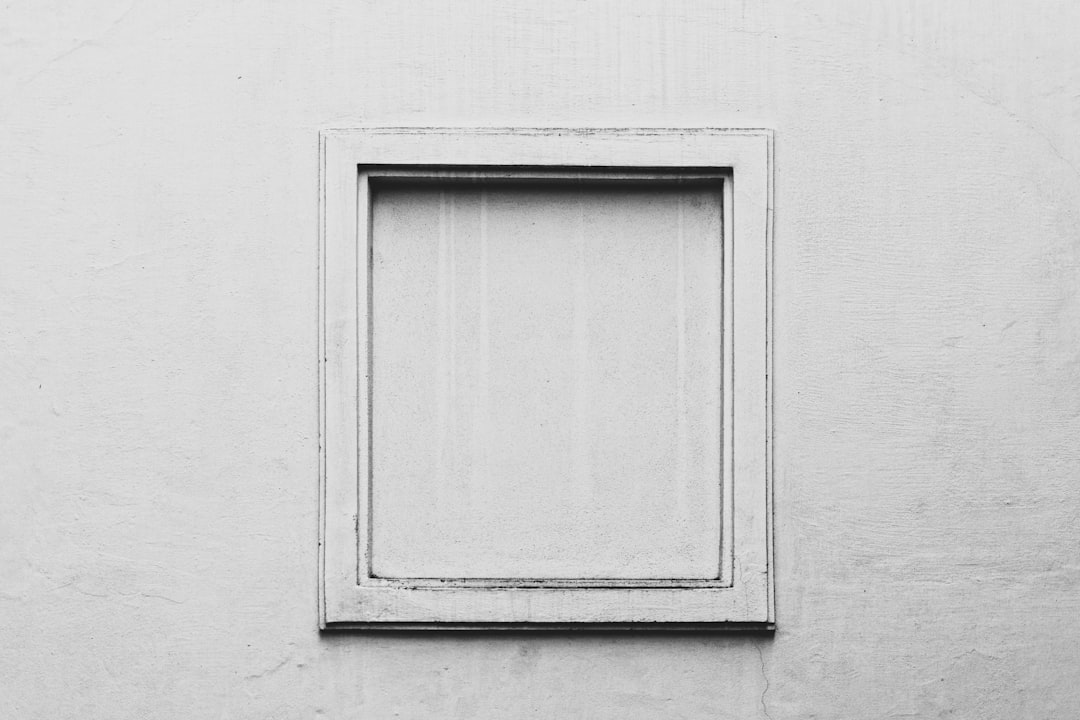 white wooden door on gray concrete wall