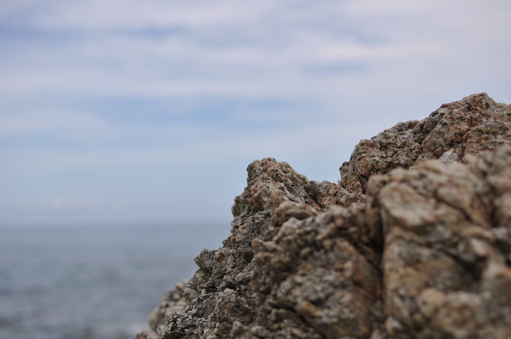 gray rock formation near body of water during daytime