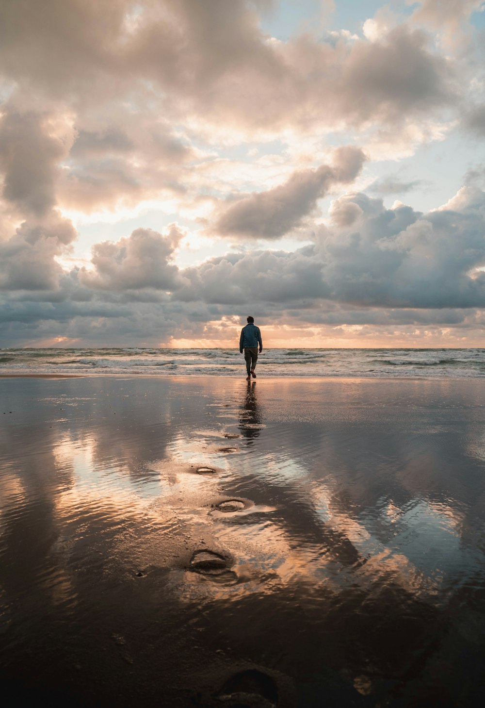 person walking on beach during daytime