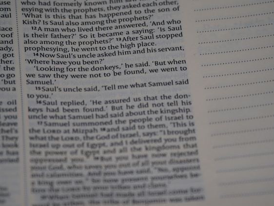 A close-up view of a page from a religious text appears, with text in English discussing biblical events involving Saul. On the right, there is a column of dotted empty lines, suggesting space for notes.