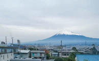 A panoramic view of Hachioji cityscape with Mount Fuji faintly visible in the distance.