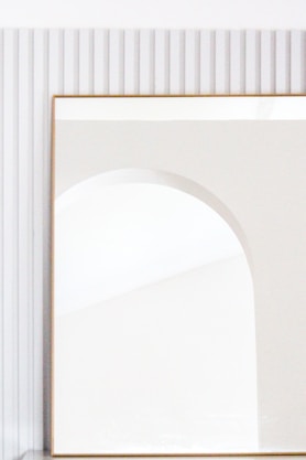 brown wooden frame on white wall