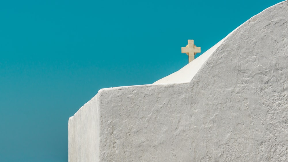 white cross on gray concrete wall