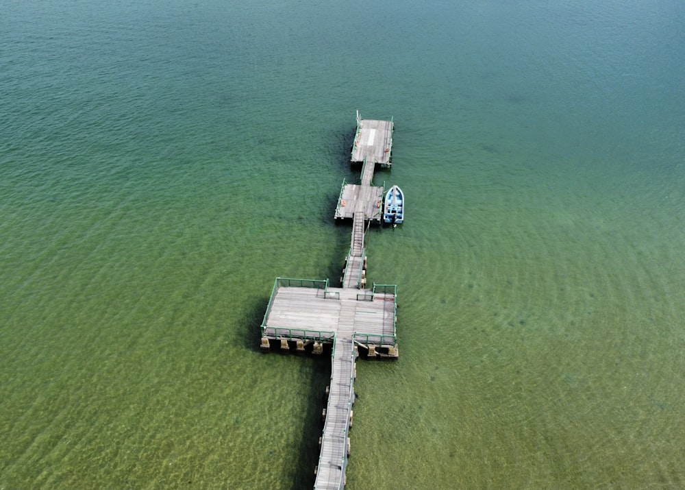 aerial view of white wooden dock on body of water during daytime