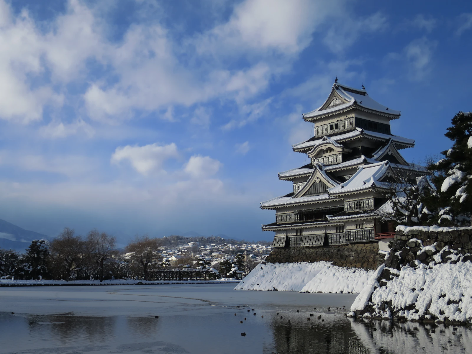 Matsumoto Castle and its moat under a blue sky in winter