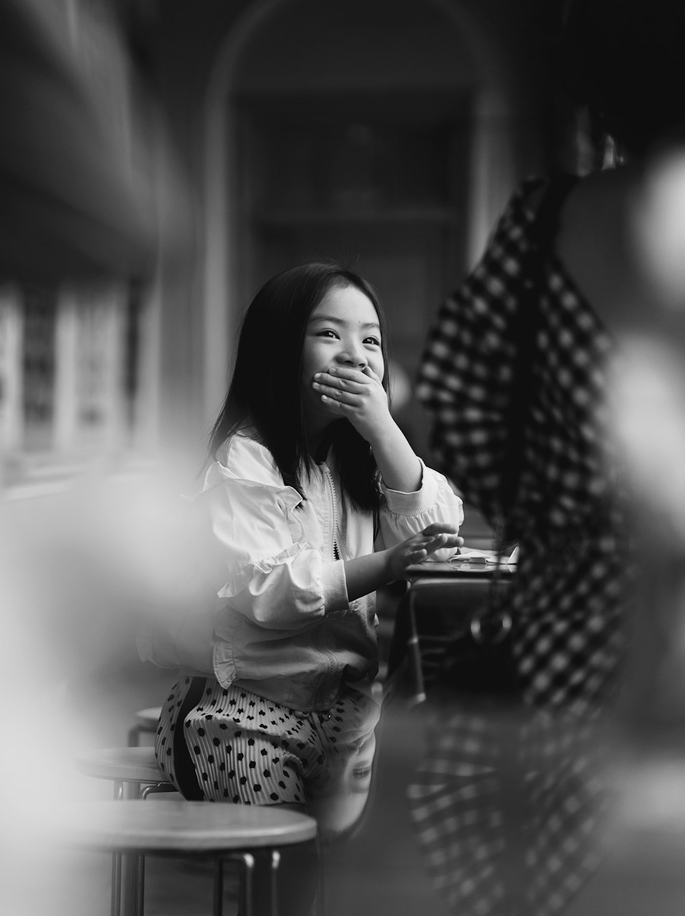 woman in white long sleeve shirt sitting on chair