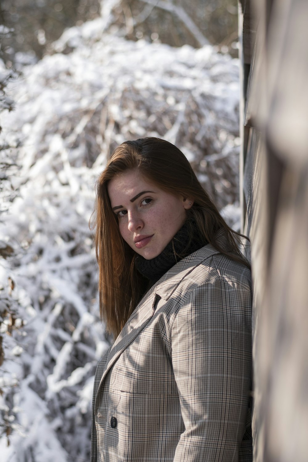 woman in gray and black plaid coat