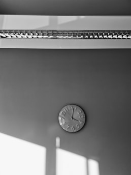 Bright digital wall clock displaying time in a contemporary living room setting