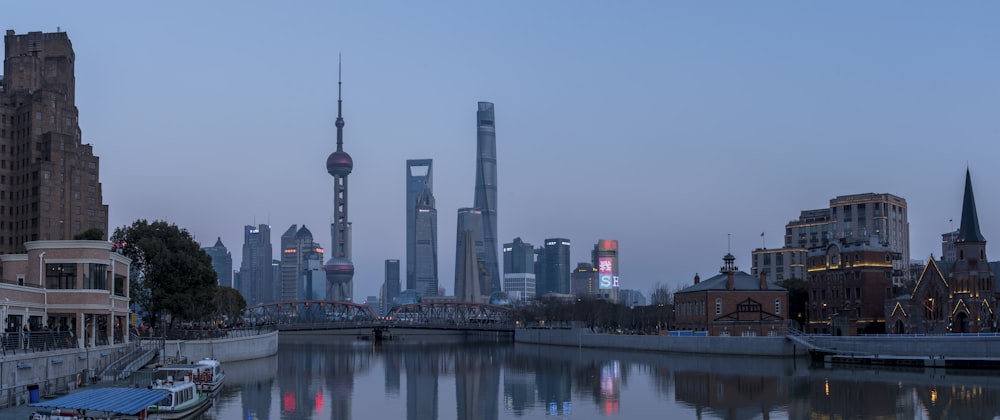 city skyline across body of water during daytime