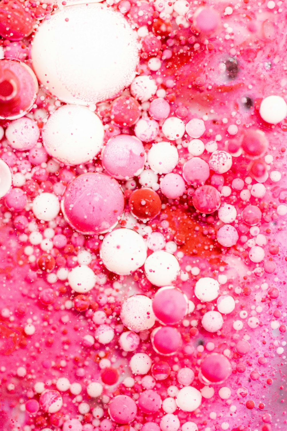 pink and white balloons on red surface