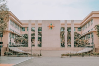 brown concrete building with flags on top