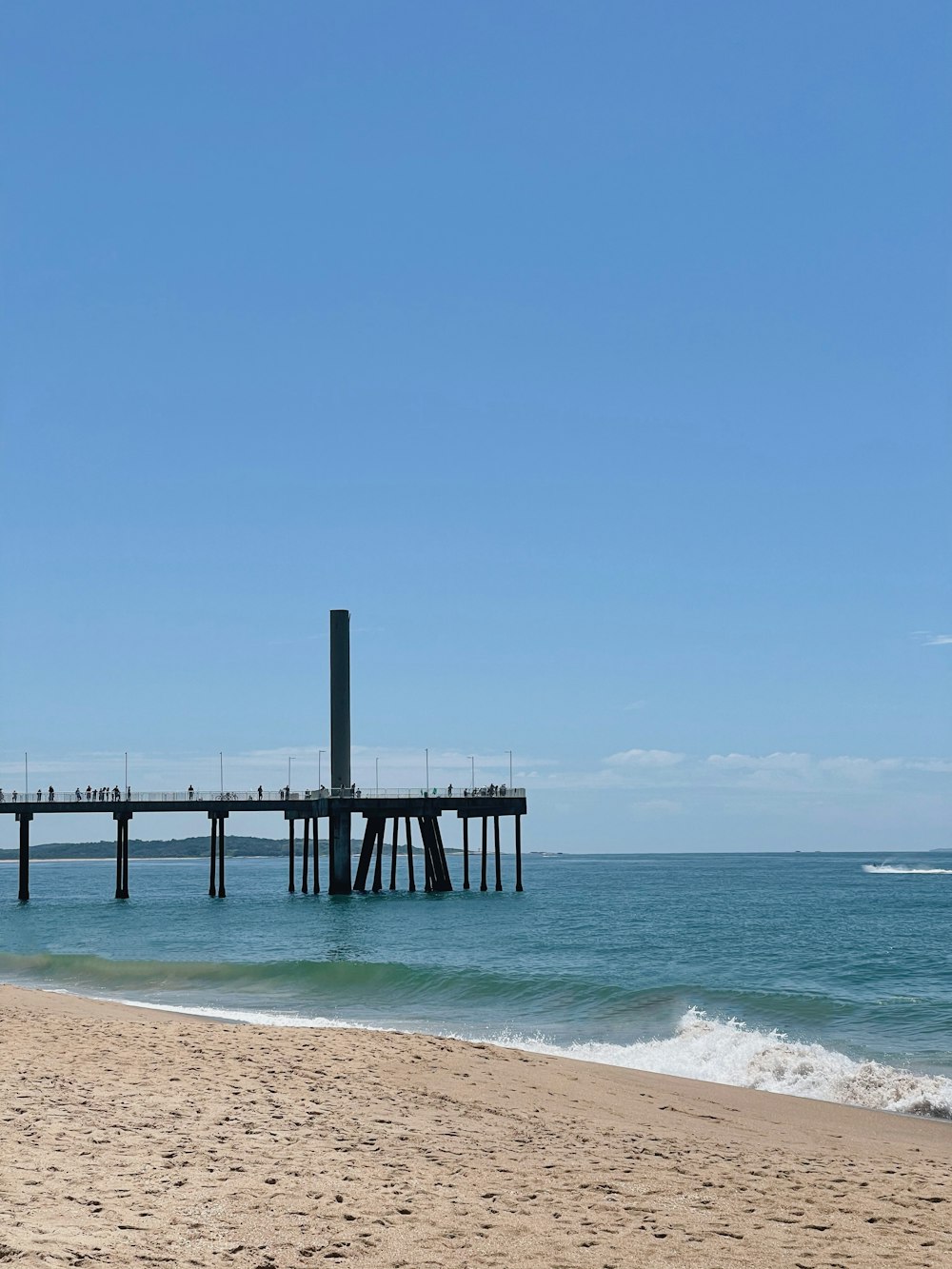 brown wooden dock on sea under blue sky during daytime