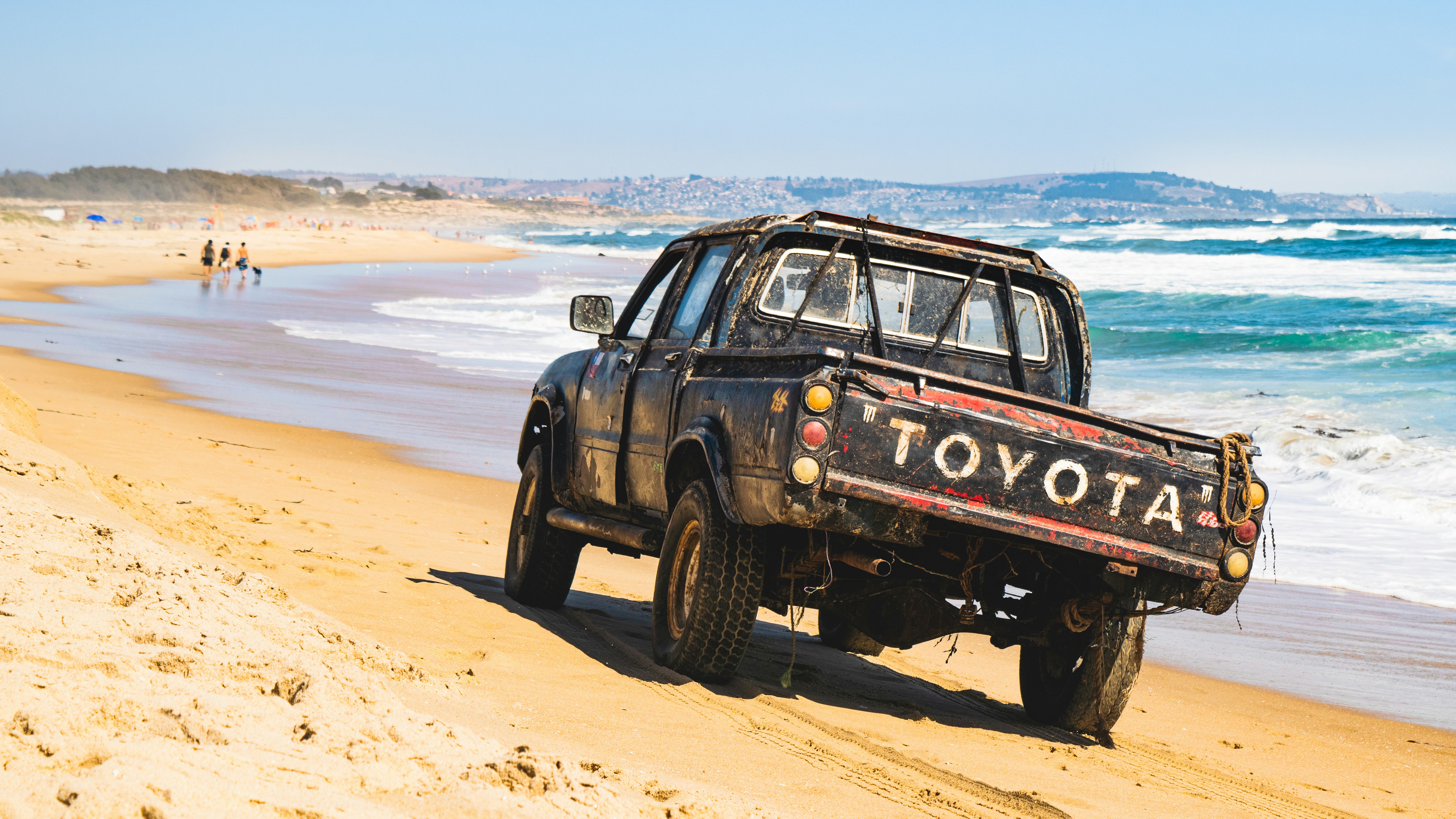 Old ute driving on a beach