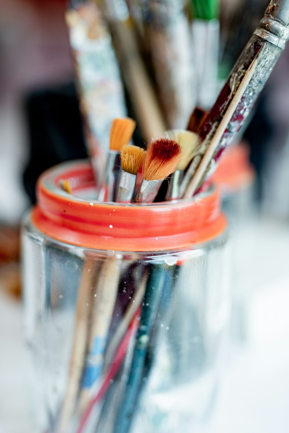 brown wooden brush in clear glass jar