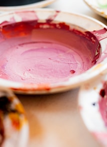 white and red ceramic bowl