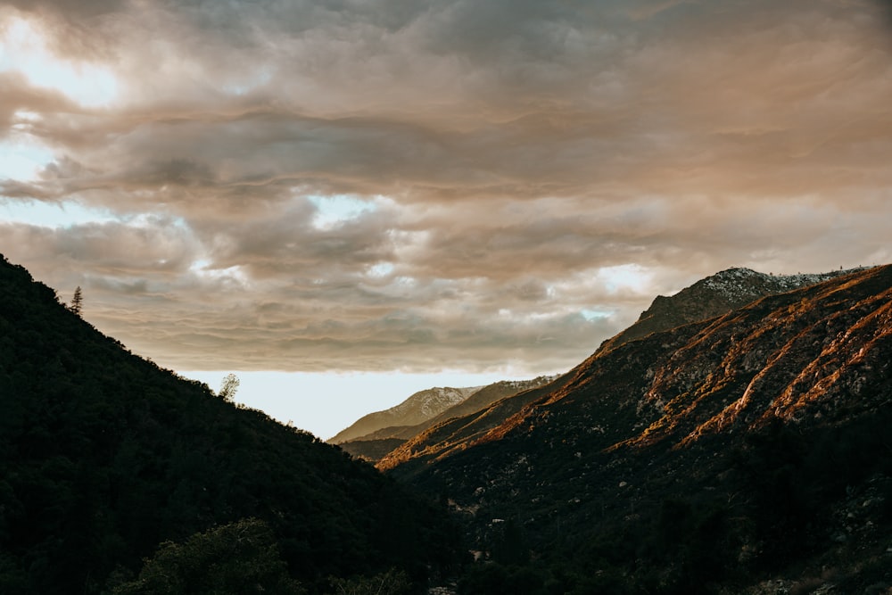 green mountains under cloudy sky during daytime