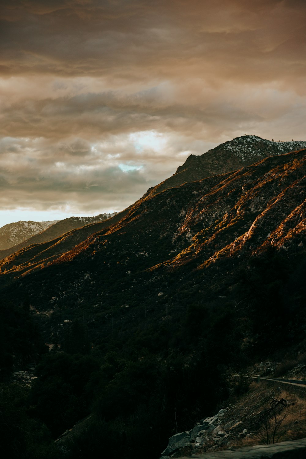 green and brown mountain under cloudy sky during daytime