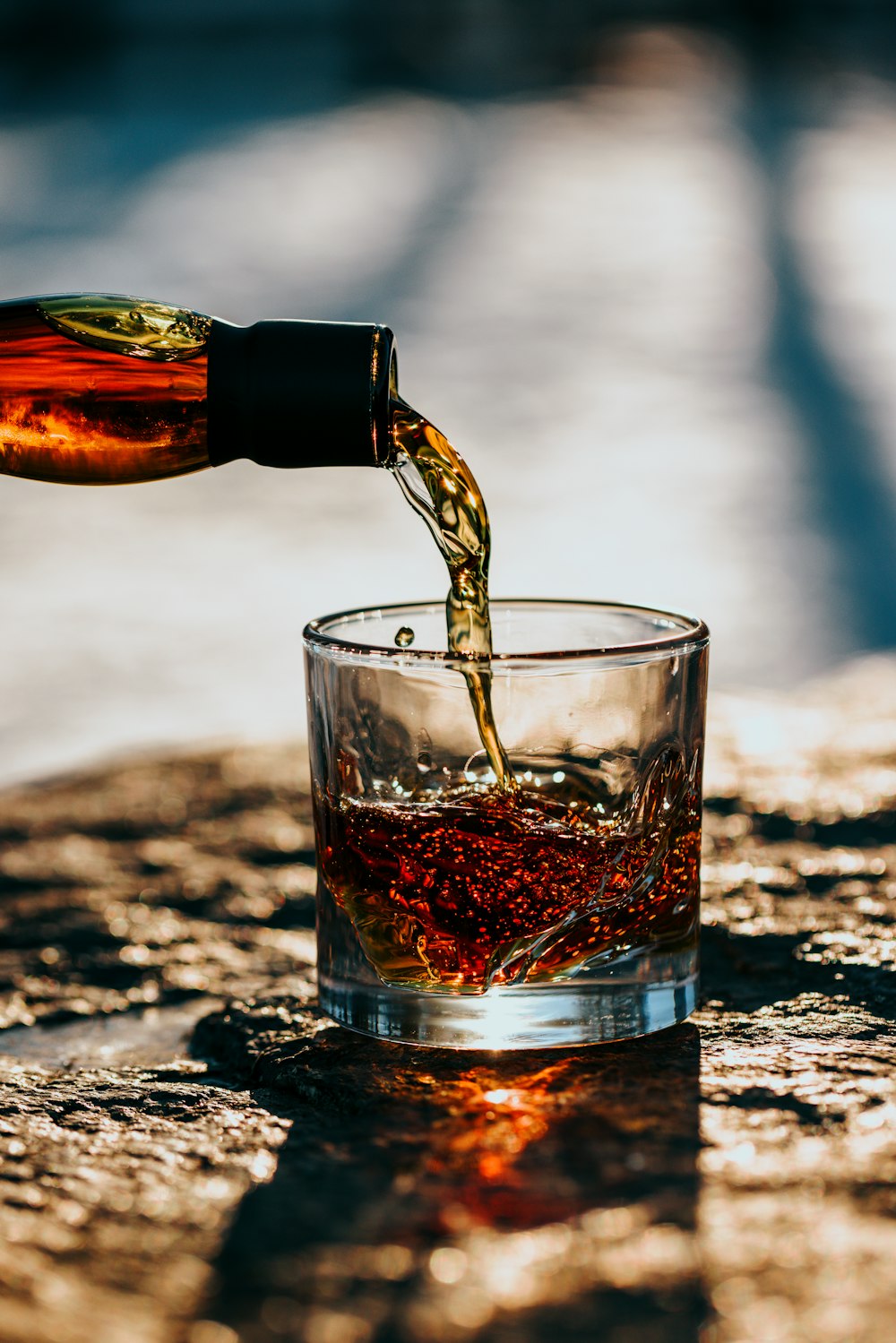 clear drinking glass with brown liquid